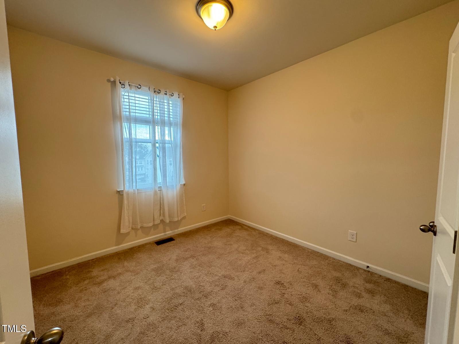 1026 Diamond Dove Lane Apex, NC 27502 - Photo 19 of 22 an empty room with windows