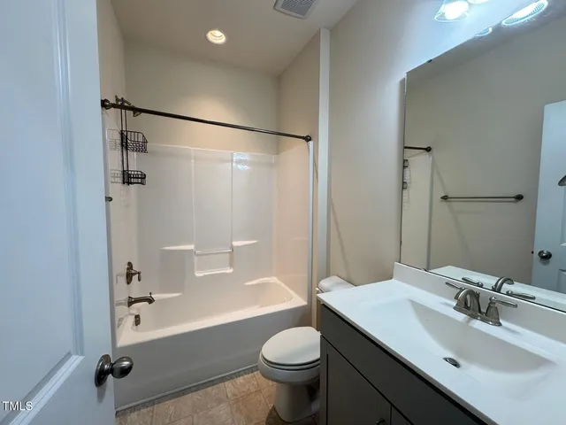 a bathroom with a sink toilet tub and shower