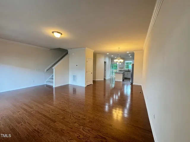 a view of a living room with hardwood floor