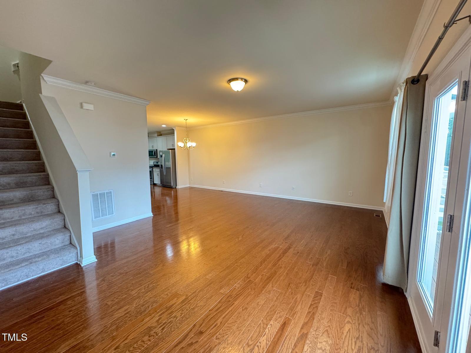 1026 Diamond Dove Lane Apex, NC 27502 - Photo 4 of 22 a view of a hallway with wooden floor