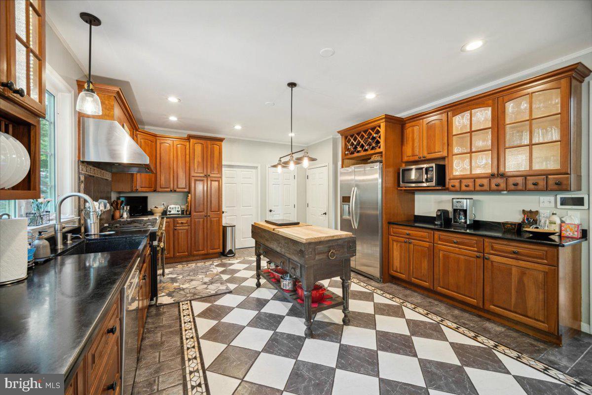 972 Smithbridge Road Glen Mills, PA 19342 - Photo 3 of 75 a kitchen with stainless steel appliances granite countertop a sink a stove a refrigerator and island with wooden floor