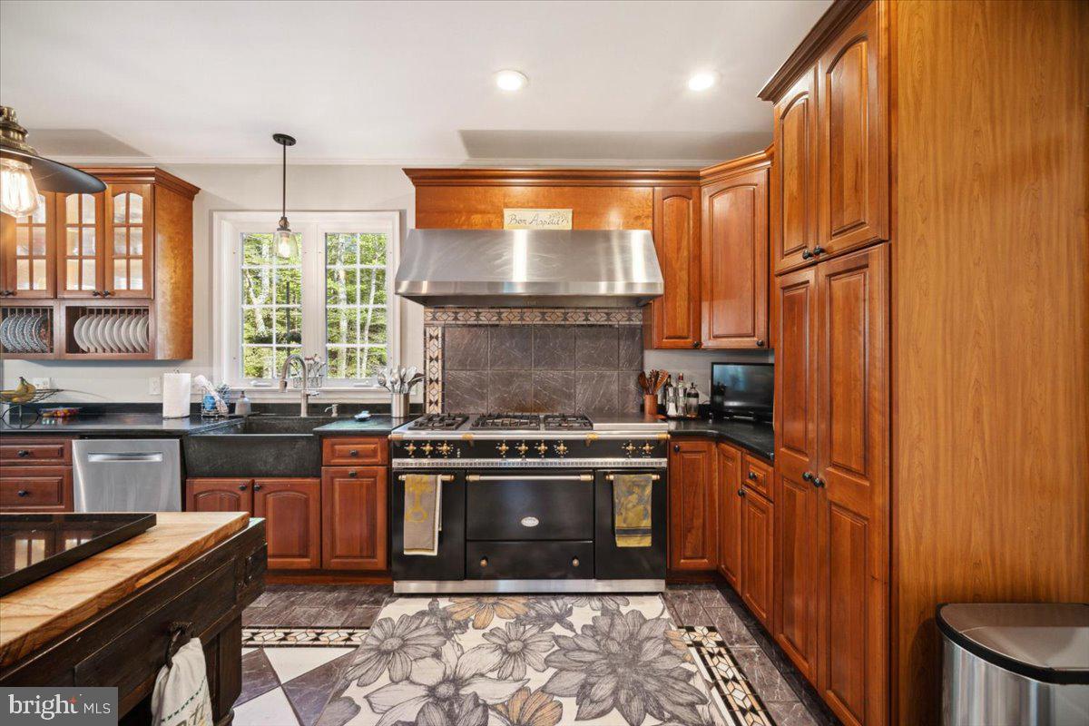 972 Smithbridge Road Glen Mills, PA 19342 - Photo 39 of 75 a kitchen with stainless steel appliances granite countertop a stove a sink and a refrigerator