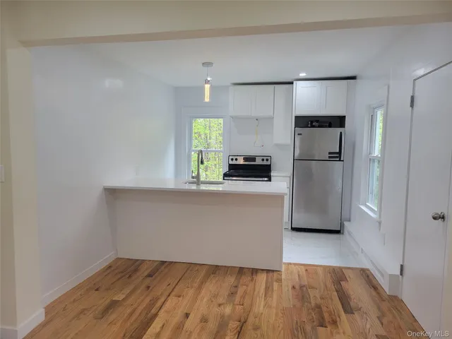 a kitchen with granite countertop a refrigerator and a stove