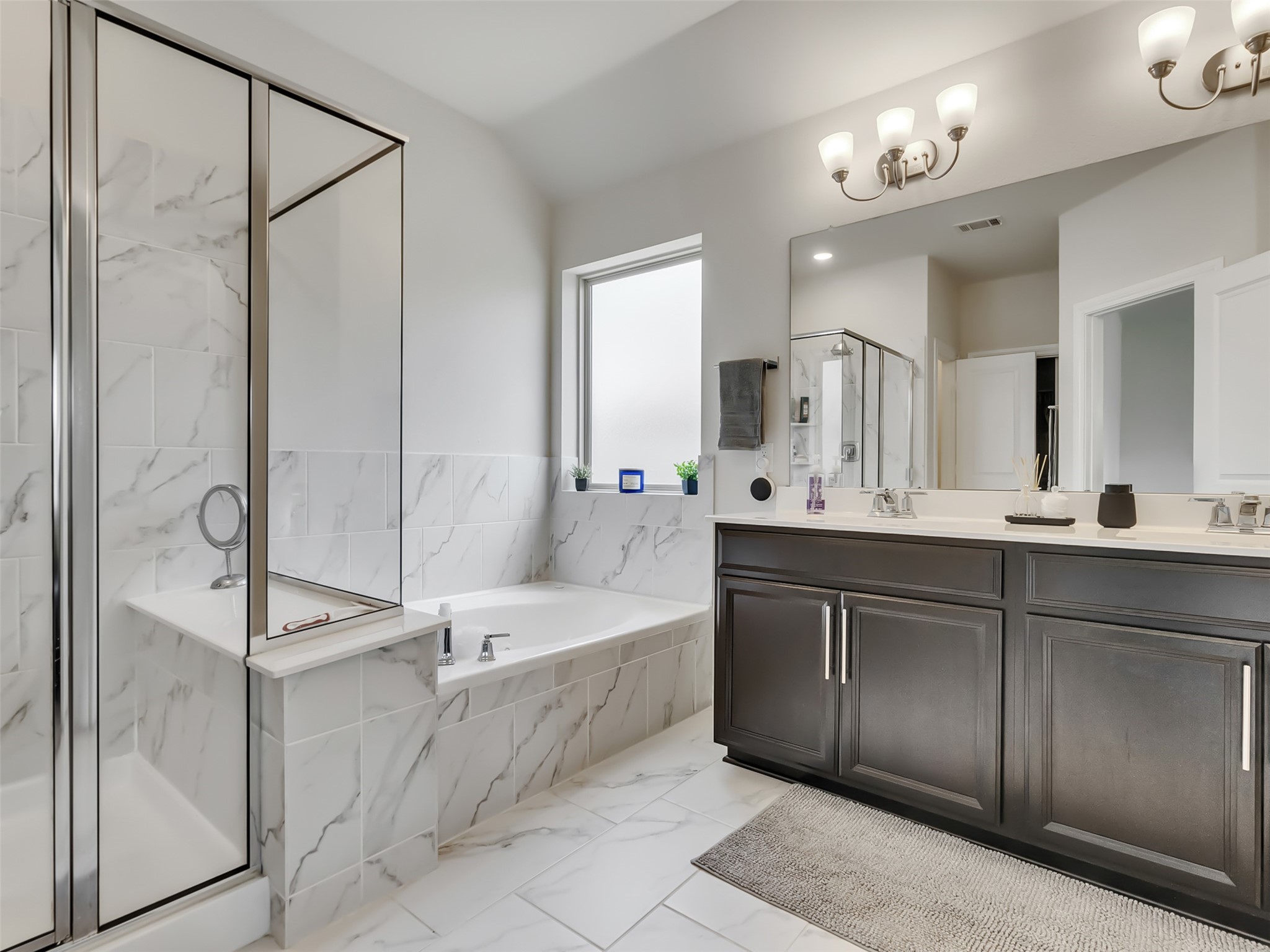 27997 Lone Hollow Lane Spring, TX 77386 - Photo 40 of 45 a spacious bathroom with a double vanity sink a mirror and a bathtub