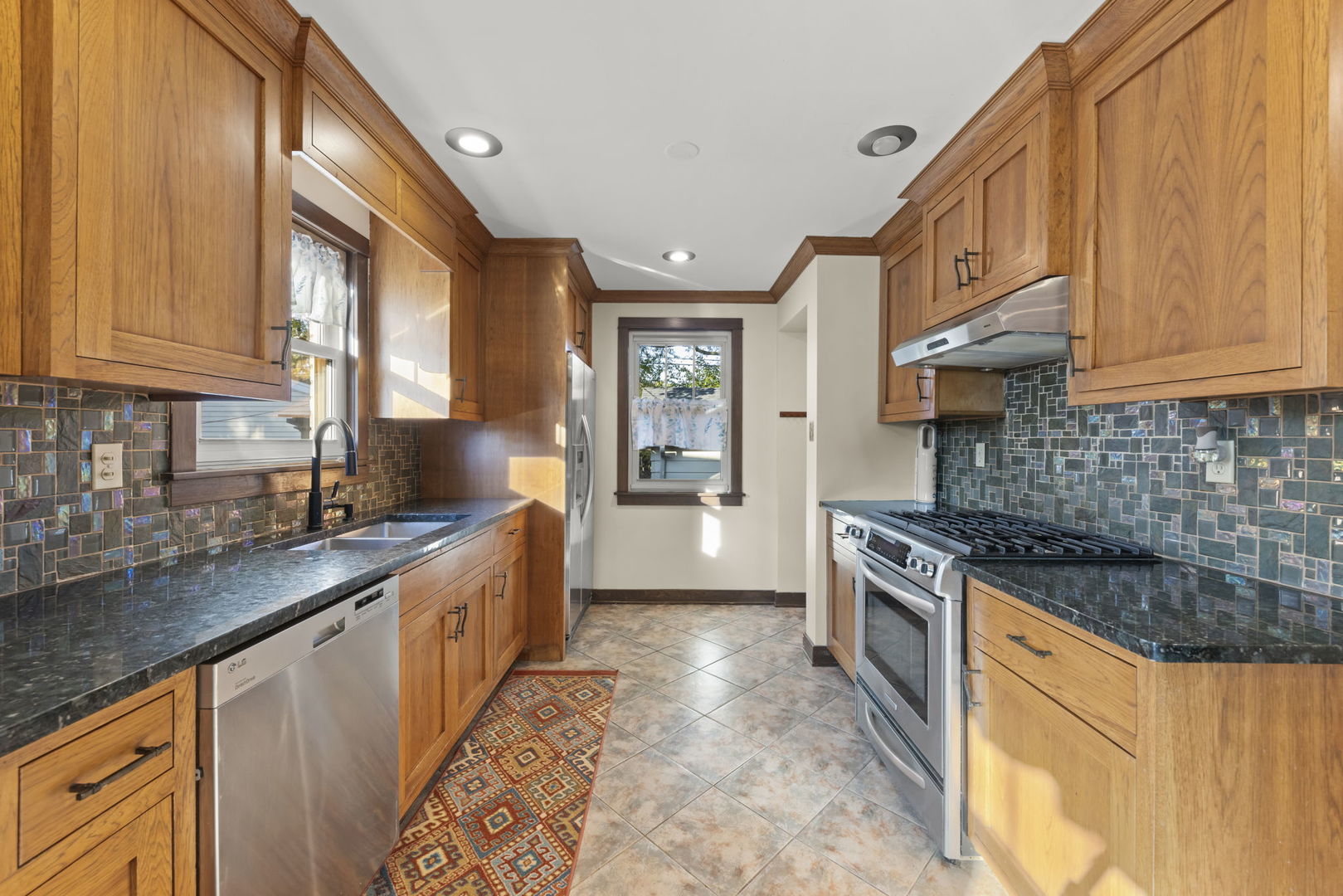 1913 Birch Road Homewood, IL 60430 - Photo 9 of 22 a kitchen with stainless steel appliances granite countertop a stove a sink and a refrigerator