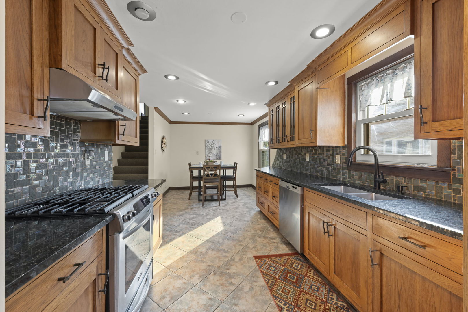 1913 Birch Road Homewood, IL 60430 - Photo 10 of 22 a kitchen with stainless steel appliances a sink stove and cabinets