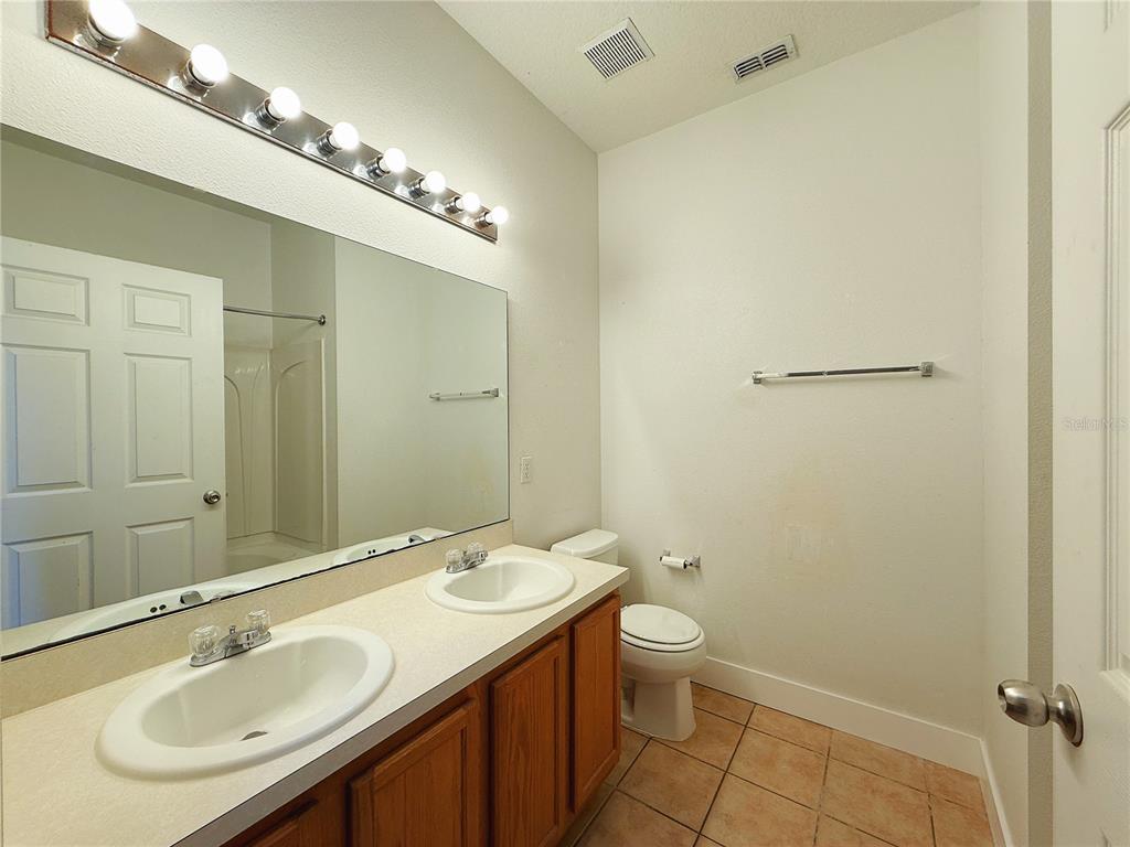 194 Sand Ridge Drive Davenport, FL 33896 - Photo 13 of 17 a bathroom with a sink and a mirror