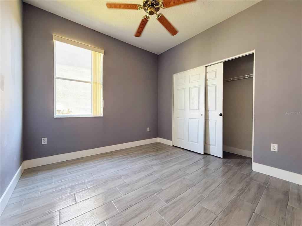 194 Sand Ridge Drive Davenport, FL 33896 - Photo 14 of 17 wooden floor in an empty room with a window