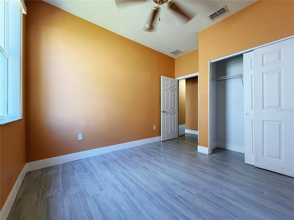 194 Sand Ridge Drive Davenport, FL 33896 - Photo 15 of 17 a view of an empty room with wooden floor and closet