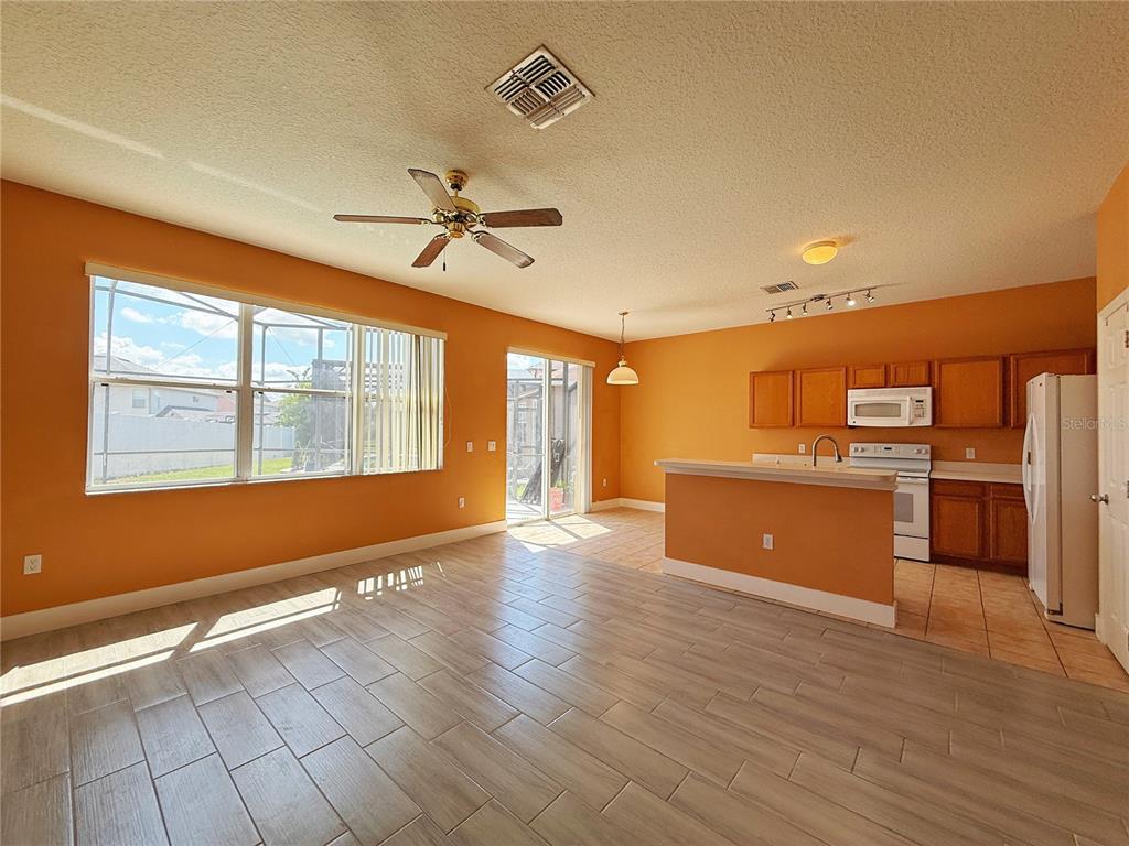 194 Sand Ridge Drive Davenport, FL 33896 - Photo 6 of 17 a view of a kitchen with wooden floor and a kitchen