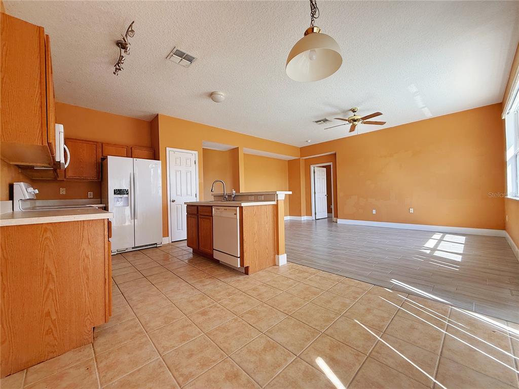 194 Sand Ridge Drive Davenport, FL 33896 - Photo 7 of 17 a view of a kitchen with a sink appliances and cabinets