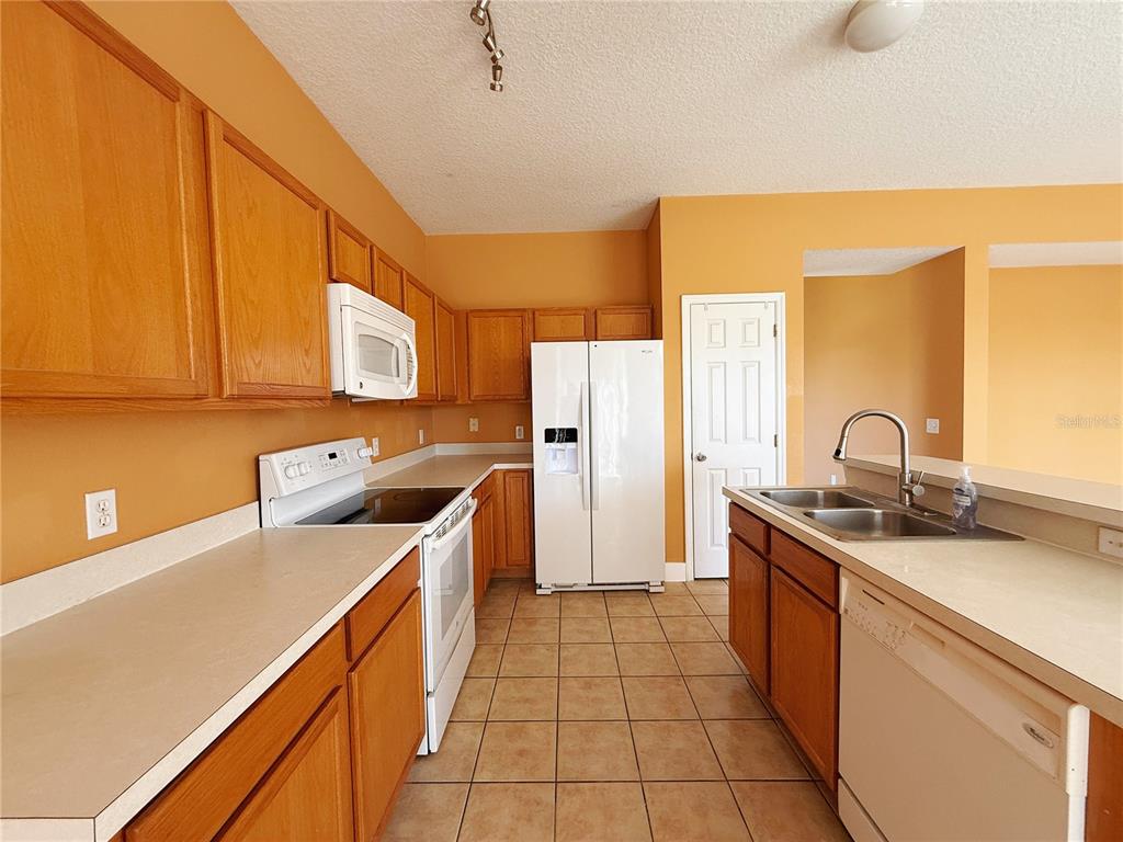 194 Sand Ridge Drive Davenport, FL 33896 - Photo 8 of 17 a kitchen with a sink and cabinets