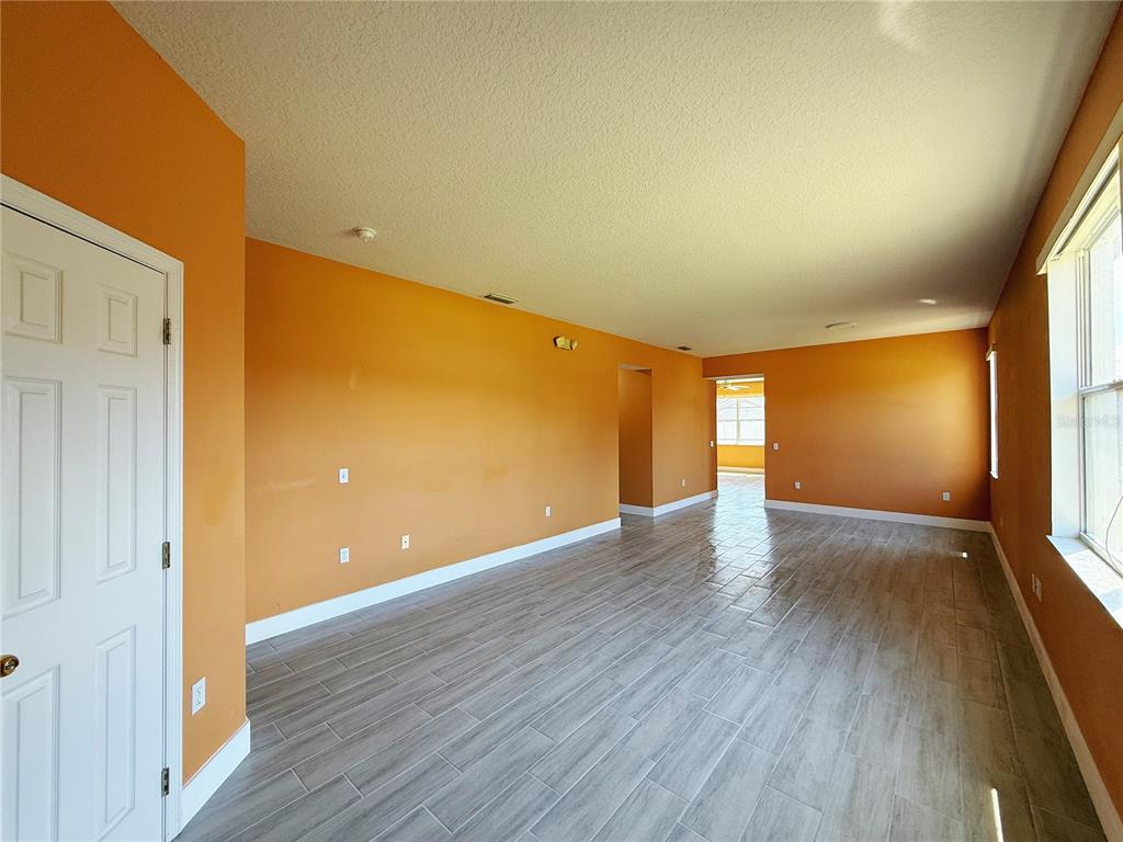 194 Sand Ridge Drive Davenport, FL 33896 - Photo 10 of 17 a view of empty room with wooden floor