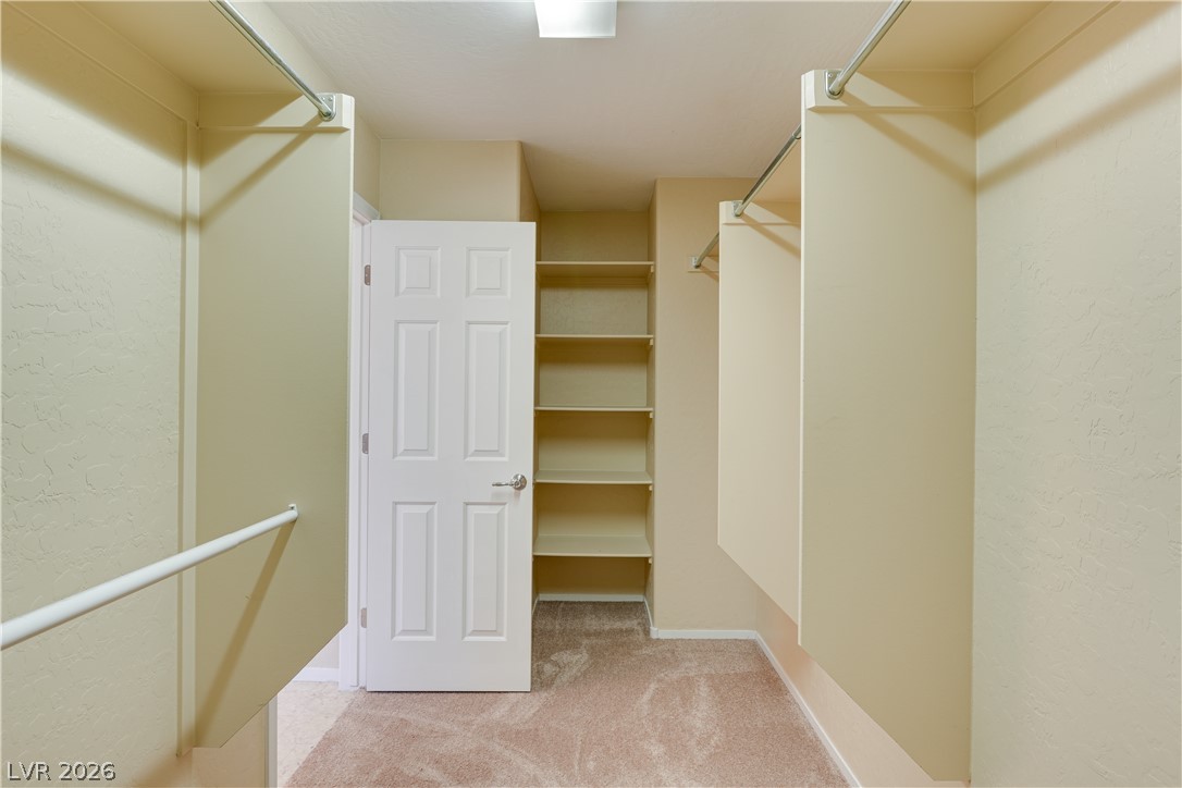 2717 Rimbaud Street Henderson, NV 89044 - Photo 25 of 34 Ample storage solutions await in this naturally illuminated walk-in closet with built-in shelving and convenient hanging rods.