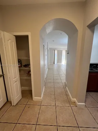 a view of a hallway to rooms and stairs