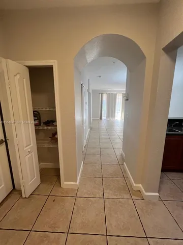 a view of a hallway to rooms and stairs