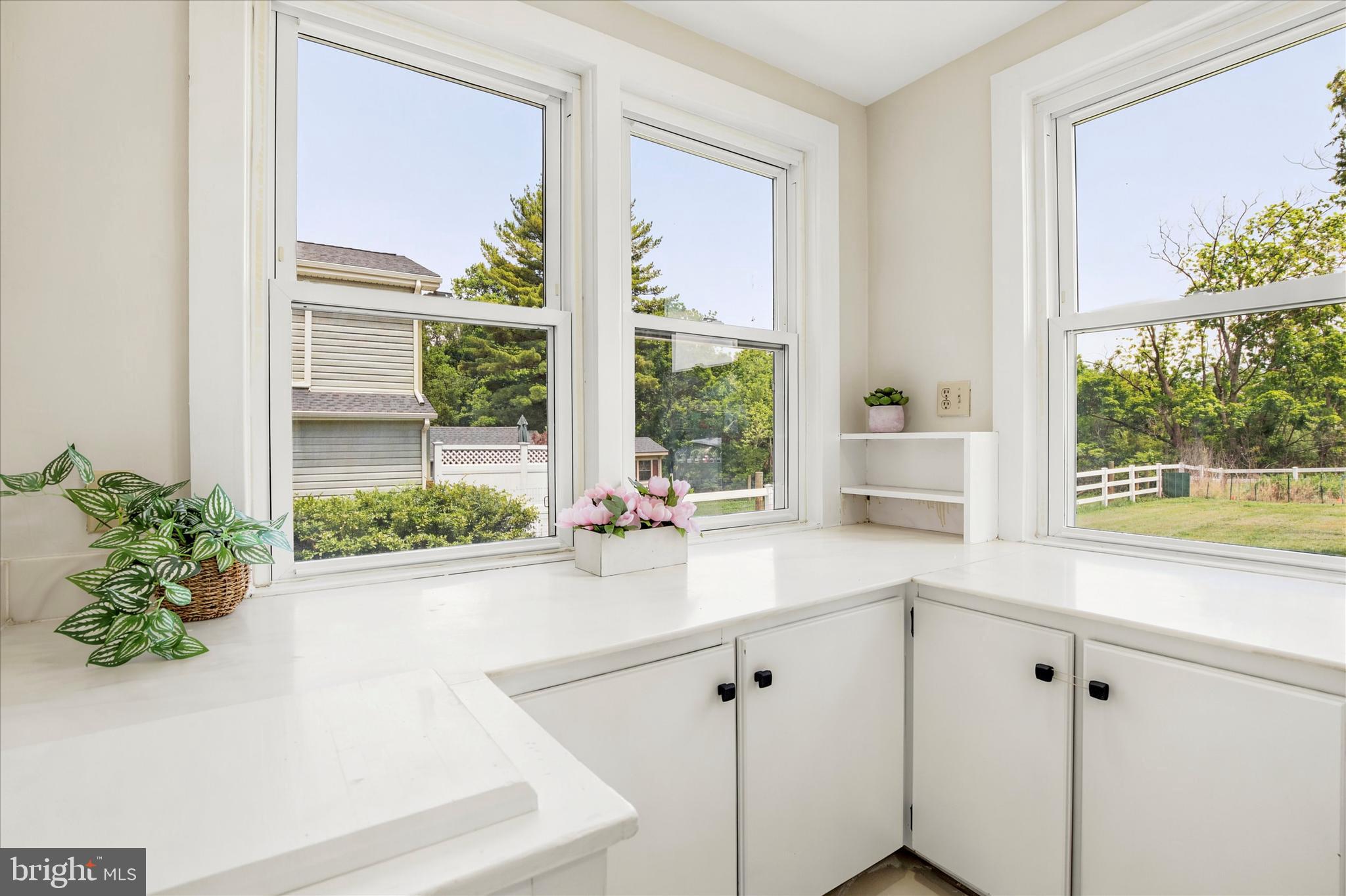 3131 Bedminster Road Ottsville, PA 18942 - Photo 5 of 23 a white kitchen with a large window sink and cabinets
