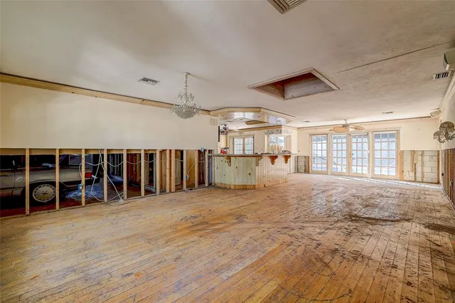 a view of a livingroom with furniture staircase and windows