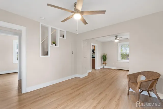 a view of a livingroom with furniture and wooden floor