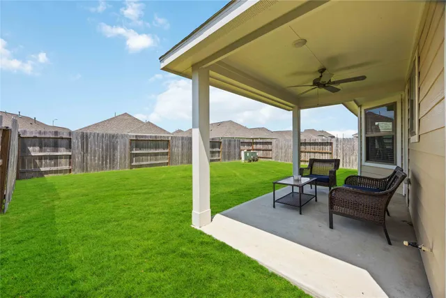 a view of a house with backyard porch and sitting area