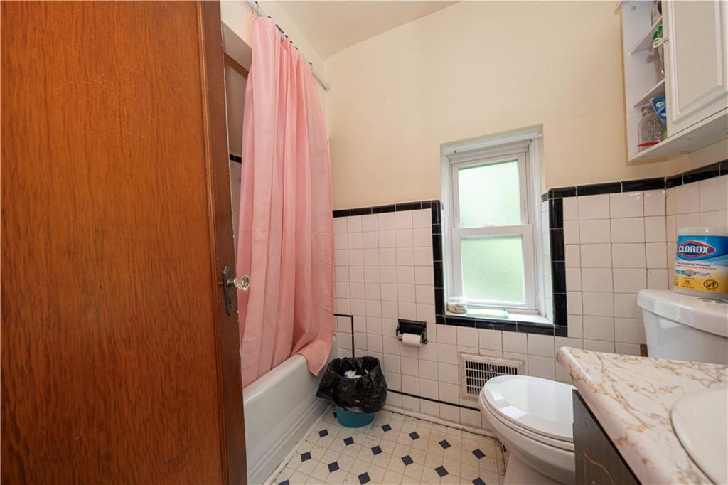 44 Forest Grove Road Coraopolis, PA 15108 - Photo 12 of 29 a bathroom with a sink a toilet and shower curtain