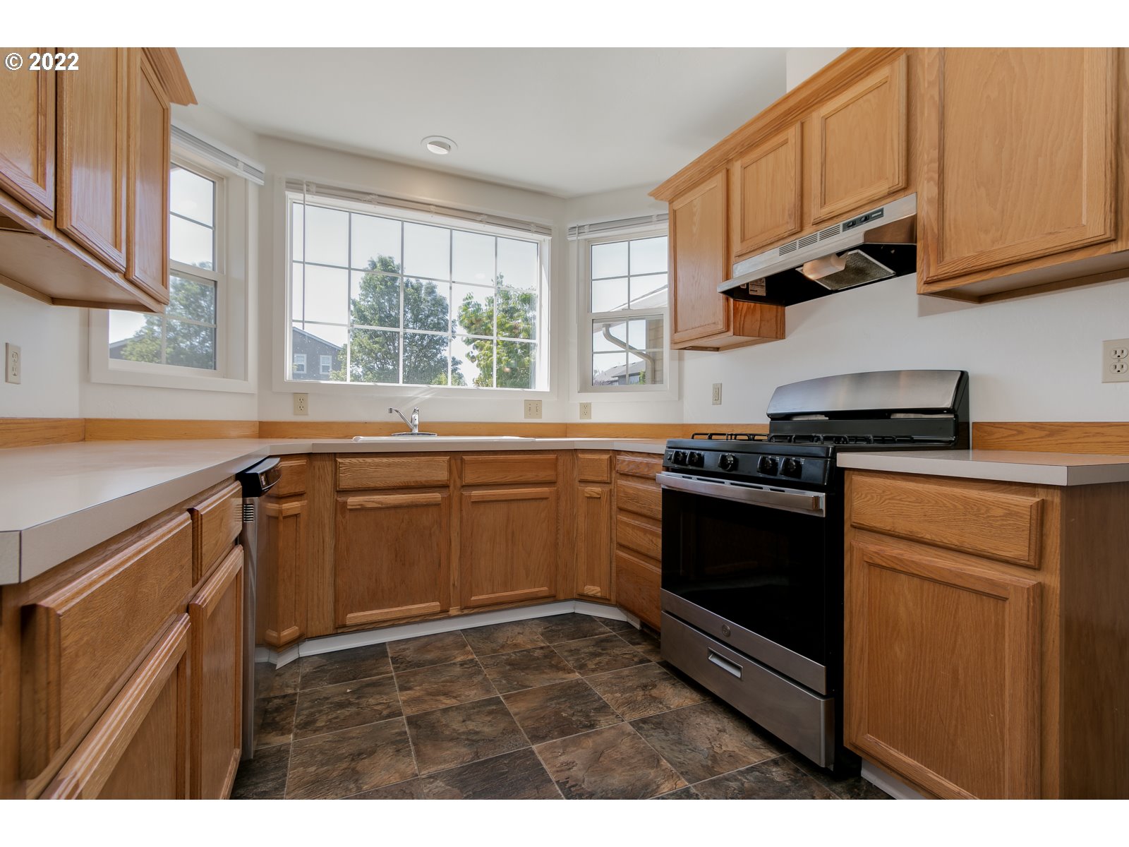 2491 Mangan Street Eugene, OR 97402 - Photo 11 of 20 a kitchen with stainless steel appliances granite countertop a stove a sink and a microwave