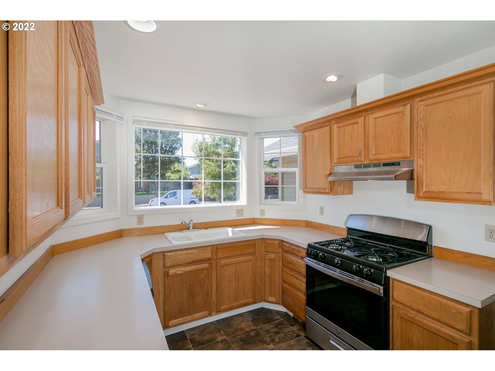 2491 Mangan Street Eugene, OR 97402 - Photo 9 of 20 a kitchen with stainless steel appliances granite countertop a stove a sink and a microwave