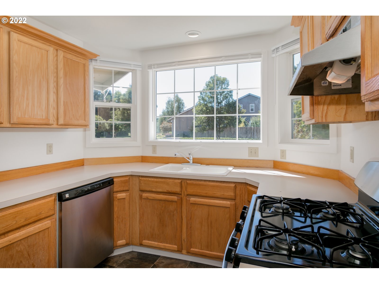 2491 Mangan Street Eugene, OR 97402 - Photo 10 of 20 a kitchen with a sink a window and cabinets