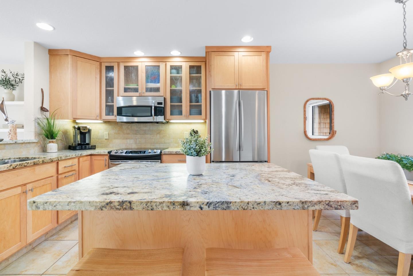 101 Shell Road, Unit 171 Watsonville, CA 95076 - Photo 11 of 31 a kitchen with granite countertop a stove a sink and a wooden cabinets