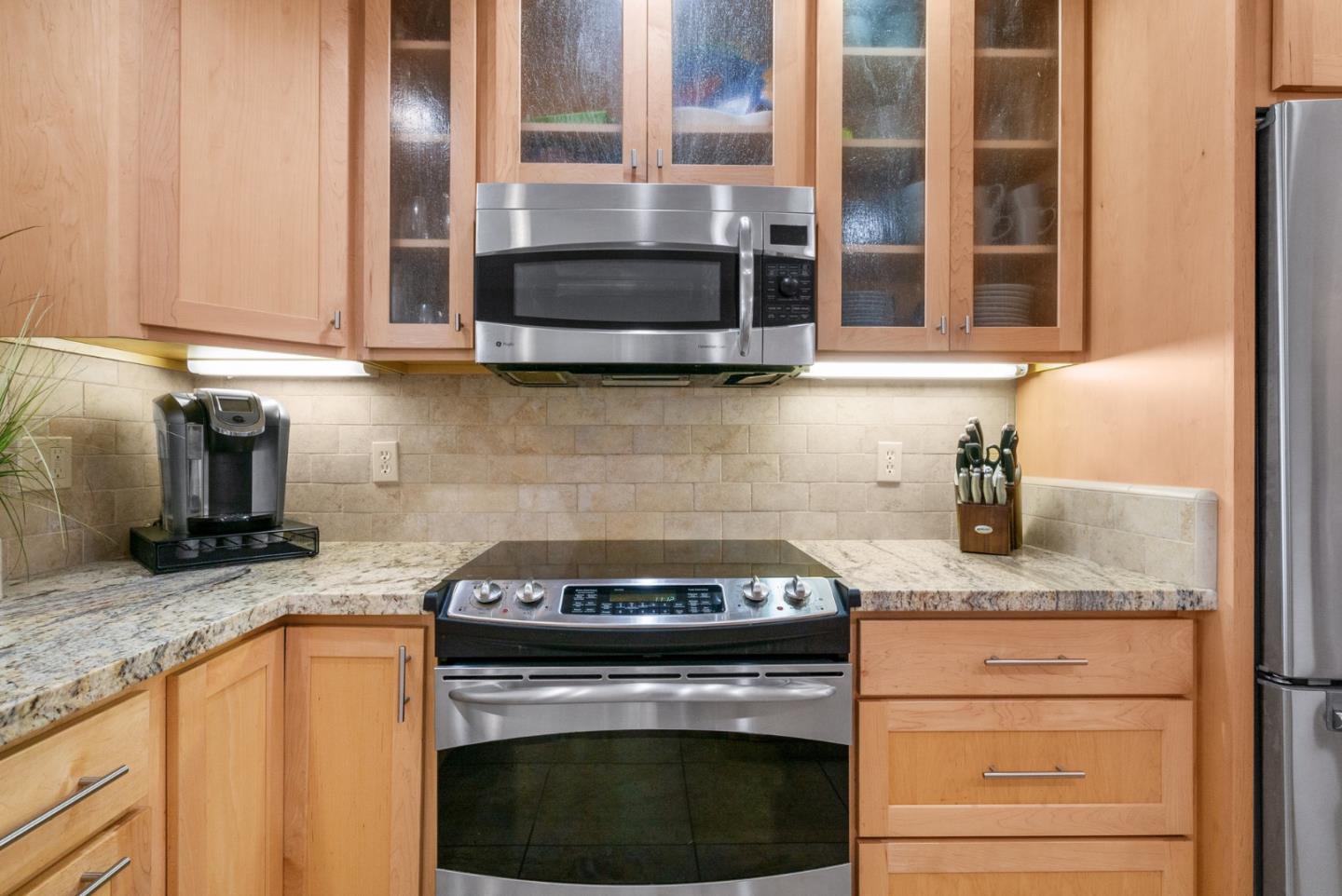 101 Shell Road, Unit 171 Watsonville, CA 95076 - Photo 14 of 31 a kitchen with granite countertop stainless steel appliances a stove a sink and a microwave