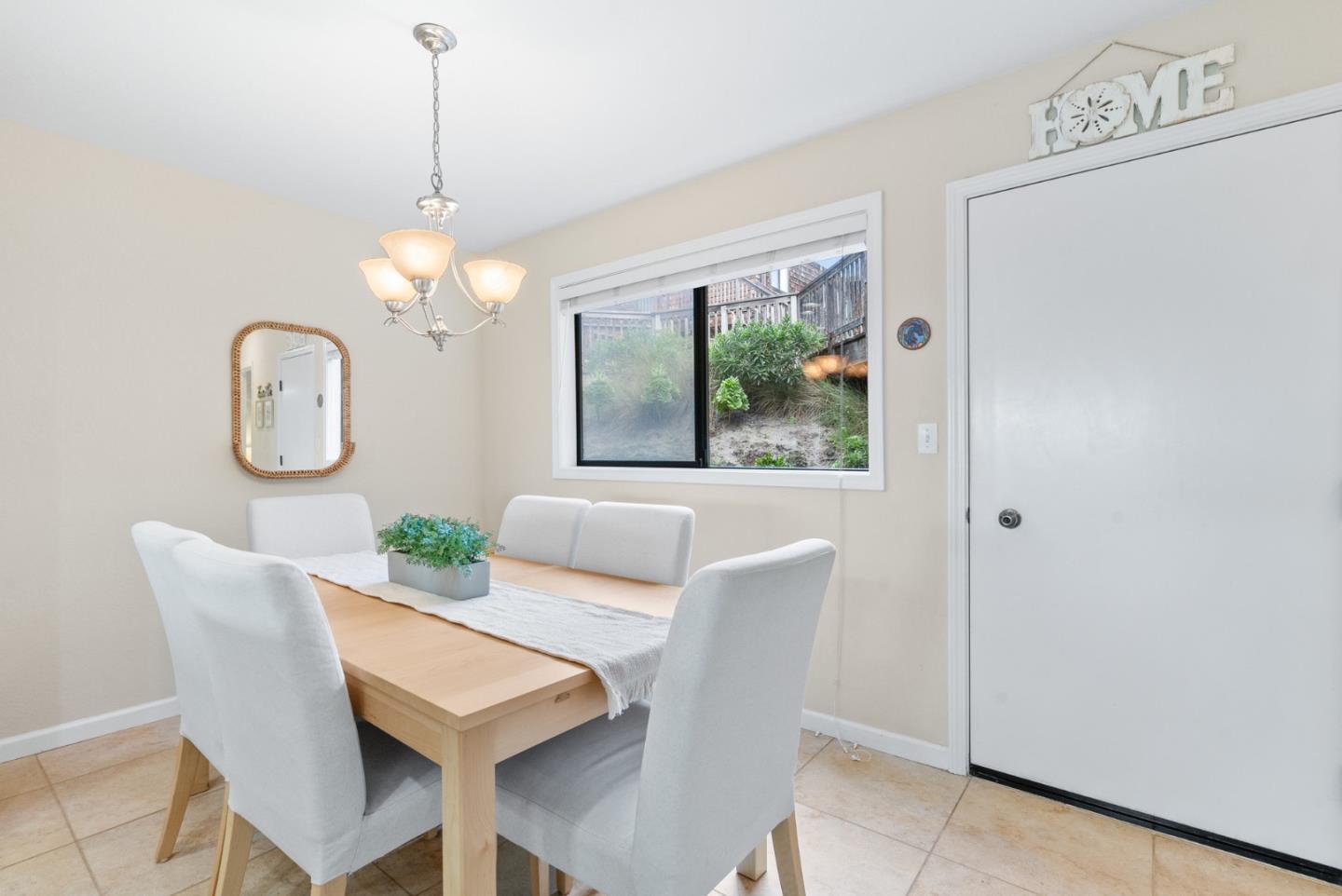 101 Shell Road, Unit 171 Watsonville, CA 95076 - Photo 17 of 31 a view of a dining room with furniture a chandelier and wooden floor