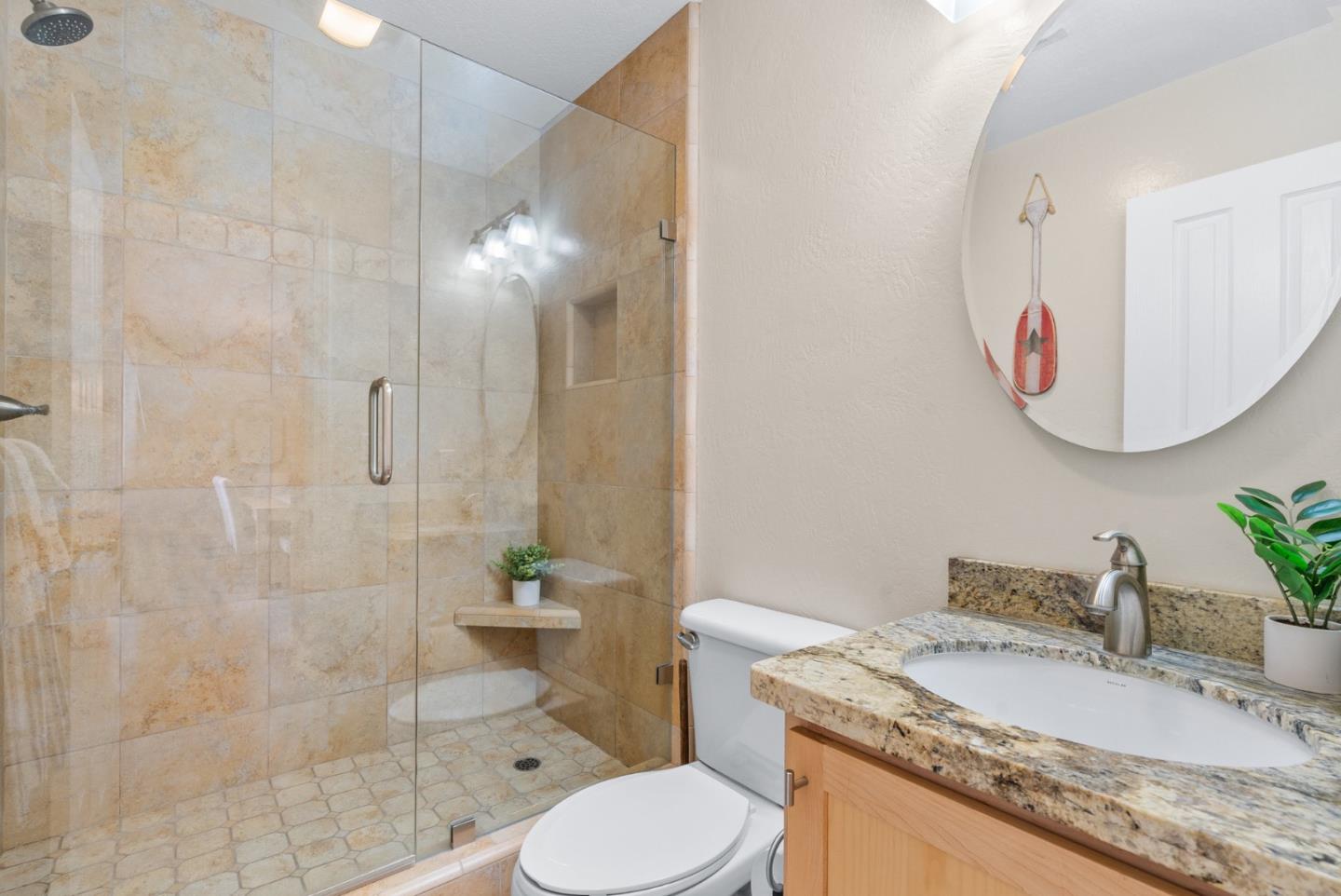 101 Shell Road, Unit 171 Watsonville, CA 95076 - Photo 21 of 31 a bathroom with a granite countertop sink mirror toilet and shower