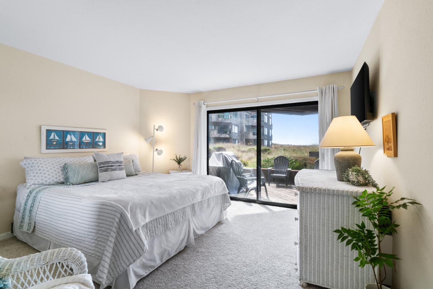 101 Shell Road, Unit 171 Watsonville, CA 95076 - Photo 22 of 31 a bedroom with a bed lamp and a large window