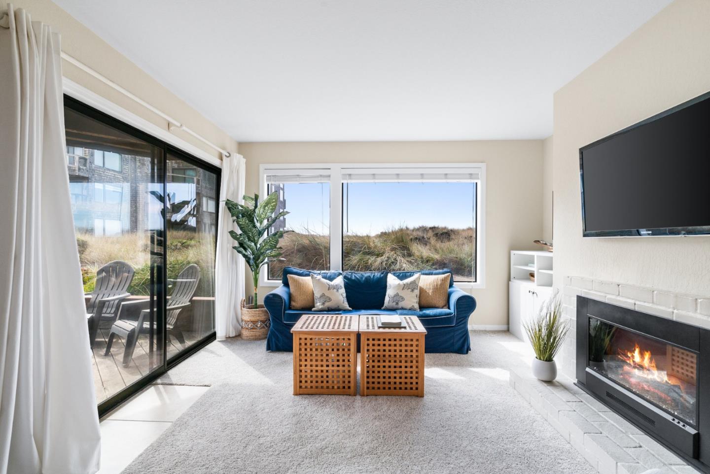 101 Shell Road, Unit 171 Watsonville, CA 95076 - Photo 4 of 31 a living room with furniture a flat screen tv and a fireplace