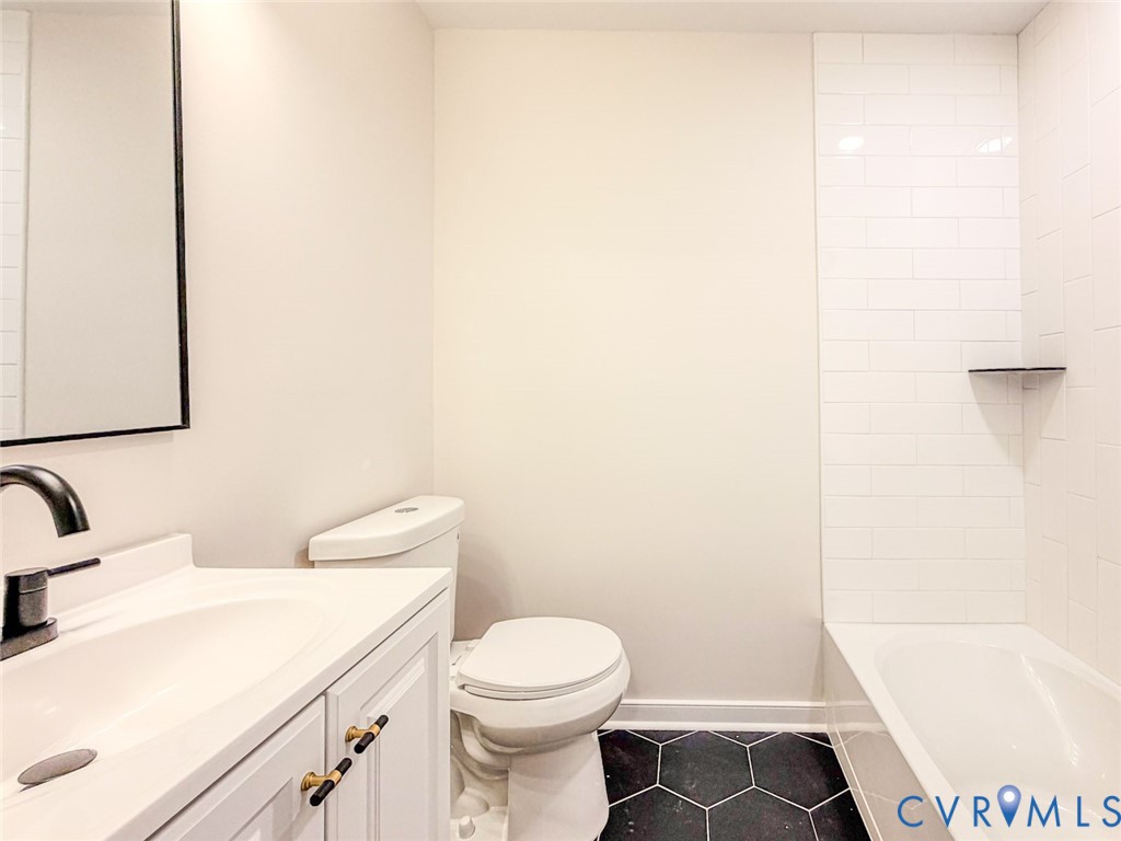 3409 Meadowbridge Road Richmond, VA 23222 - Photo 16 of 32 a bathroom with a sink a toilet and a bathtub