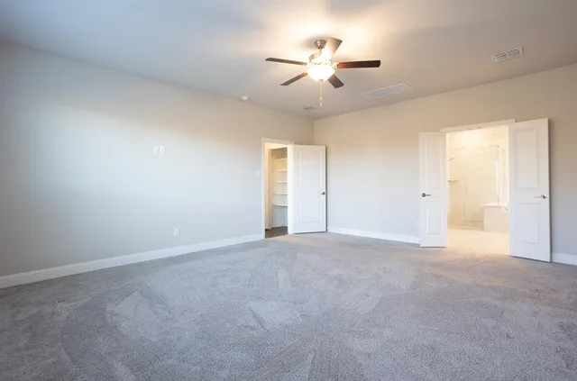 a large spacious bathroom with a shower a sink and a mirror