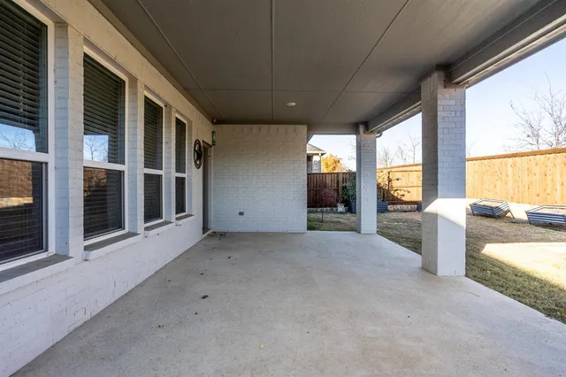 a view of a house with a yard and wooden fence