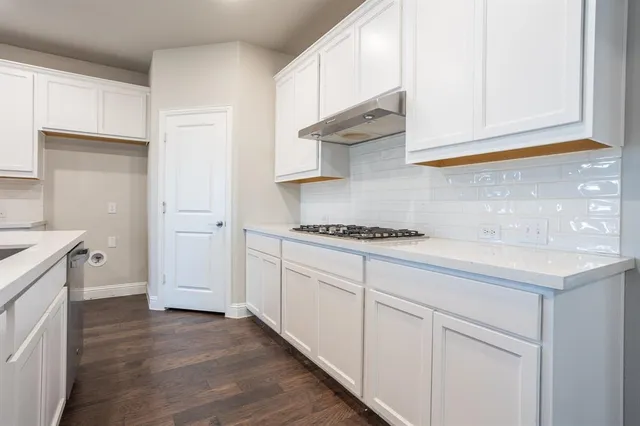 a kitchen with granite countertop a sink and a stove