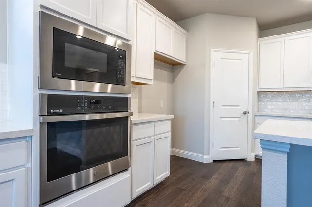 a kitchen with stainless steel appliances and cabinets