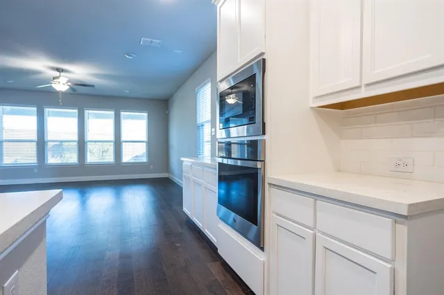 a kitchen with stainless steel appliances granite countertop a stove and a refrigerator