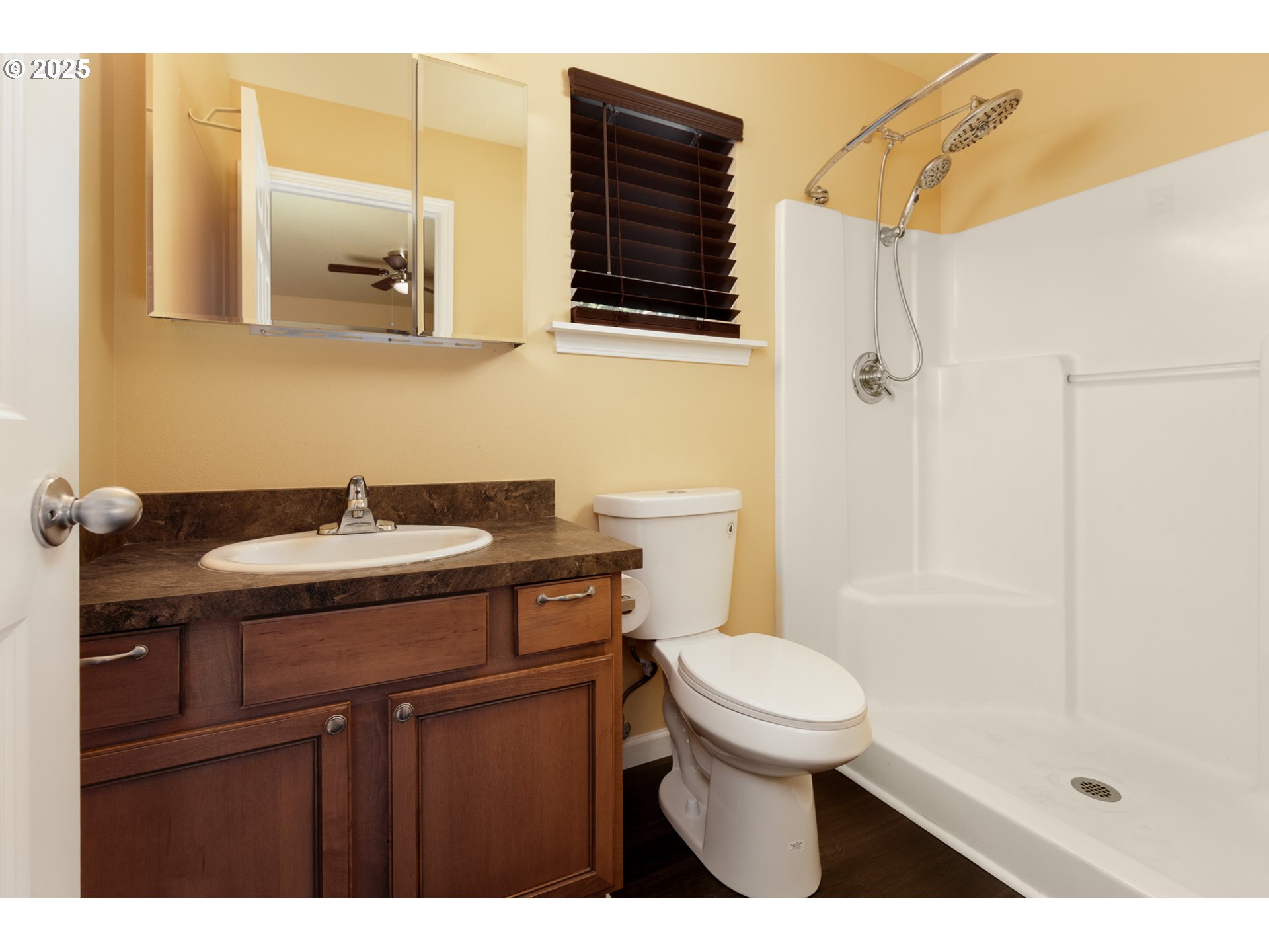 1016 Clark Street The Dalles, OR 97058 - Photo 12 of 24 a bathroom with a sink a toilet a mirror and shower