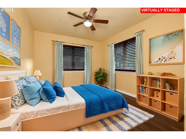 a bedroom with a bed a dresser with wooden floor