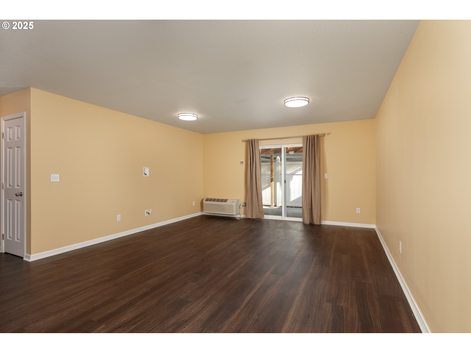 1016 Clark Street The Dalles, OR 97058 - Photo 5 of 24 a view of an empty room with wooden floor and a window