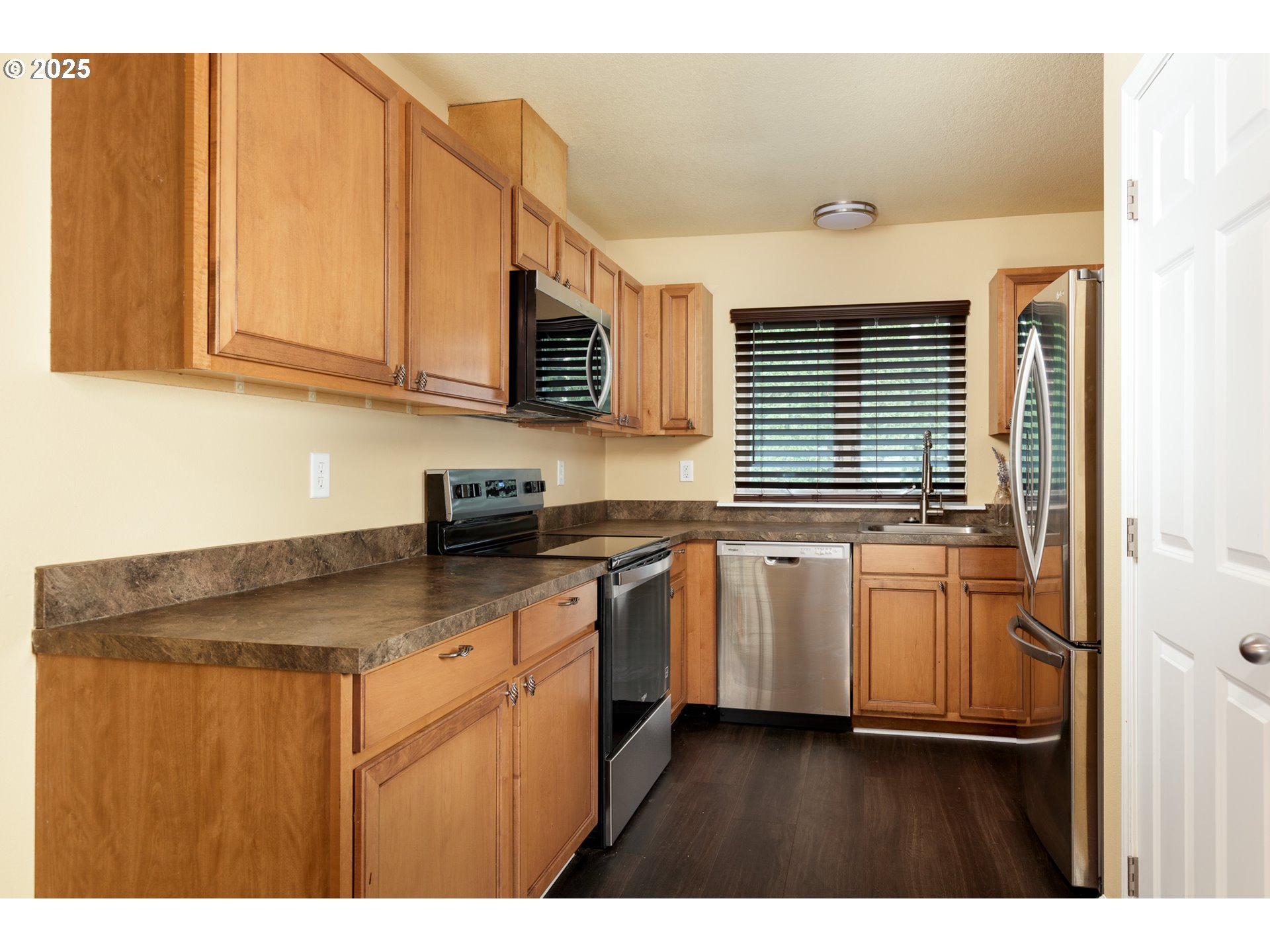 1016 Clark Street The Dalles, OR 97058 - Photo 7 of 24 a kitchen with kitchen island granite countertop a sink cabinets and stainless steel appliances