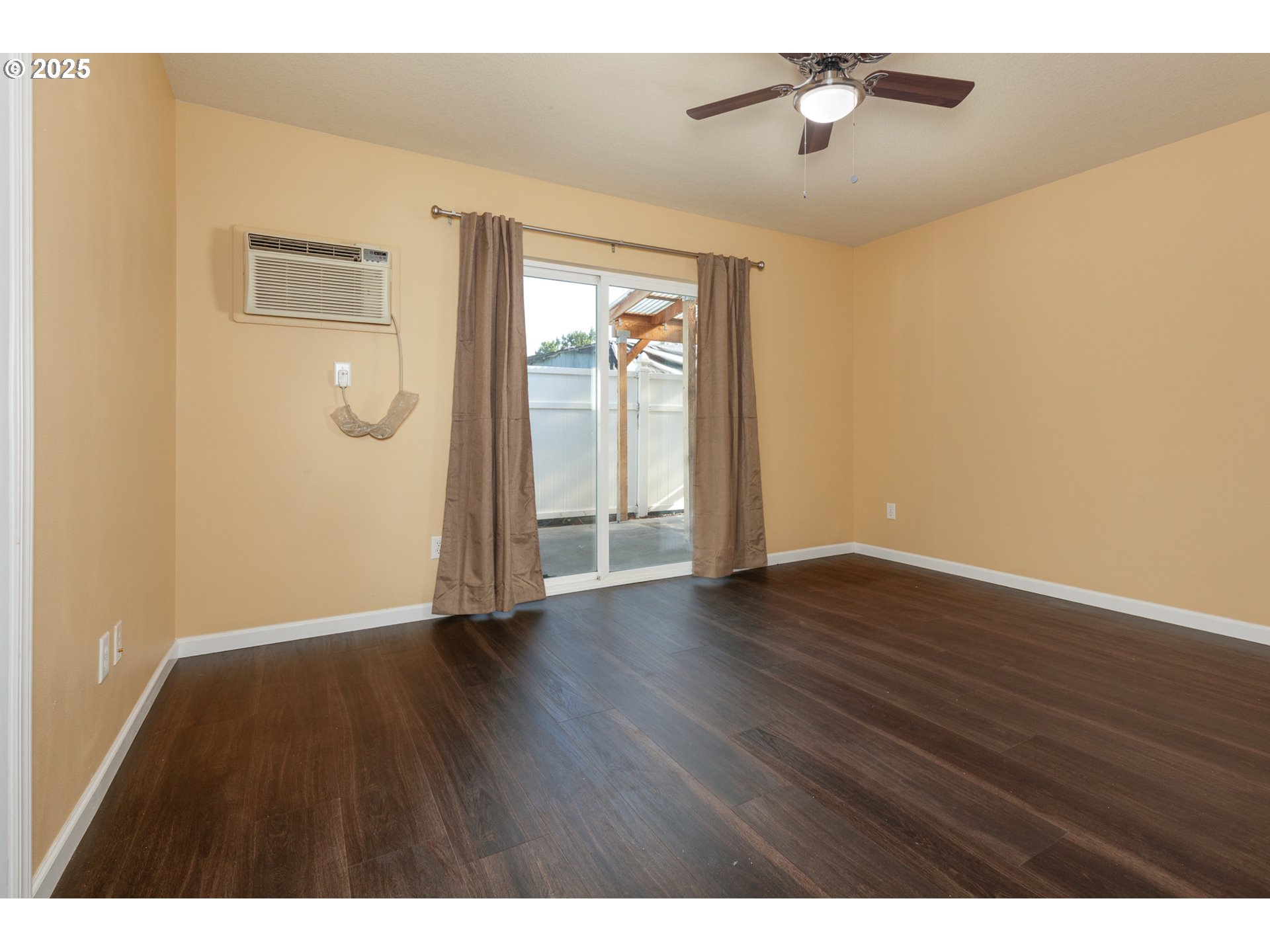 1016 Clark Street The Dalles, OR 97058 - Photo 10 of 24 a view of an empty room with wooden floor and a window