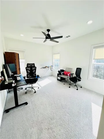 a view of a livingroom with workspace and a window