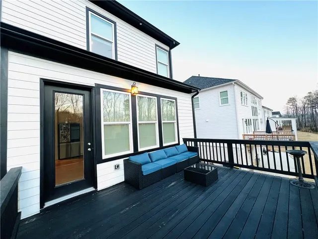 a view of a house with wooden deck