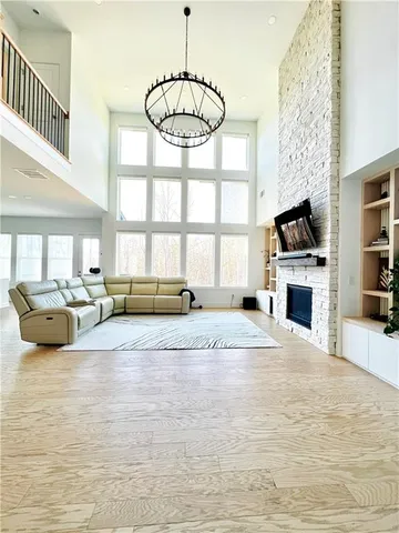 a view of a livingroom with a fireplace and a window