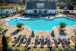 an aerial view of a house with swimming pool garden and patio