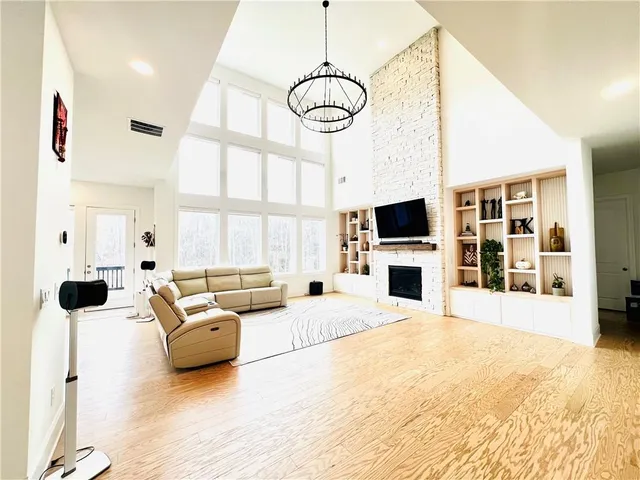 a living room with furniture large window and flat screen tv
